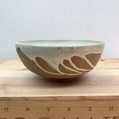 Terracotta bowl with cream glaze drips
