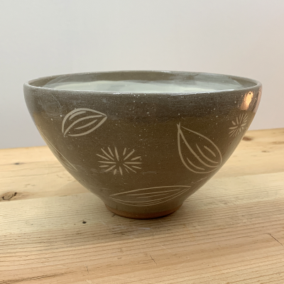 Brown bowl with white shapes