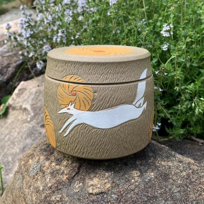 Lidded jar with white foxes and yellow flowers, by La Datcha